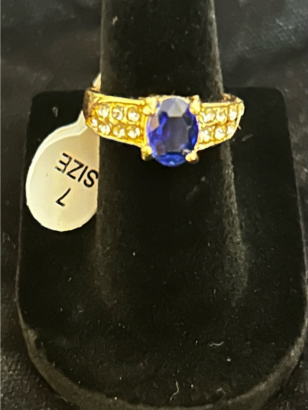 Gold tone Ring with Deep Blue Oval Stone and Accent Crystals